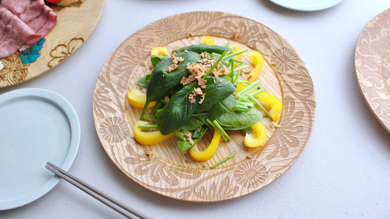 Natural wooden plate with floral pattern on the rim