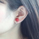 Clip-on earrings for both ears.