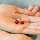 Clip-on earrings for both ears.